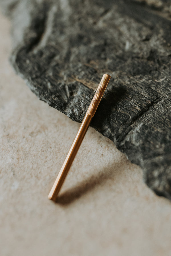 a small metal tool on a rock